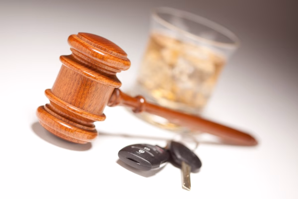 SR-22 Insurance 1 A gavel near car keys and a glass of whiskey to illustrate SR-22 after a DUI in California